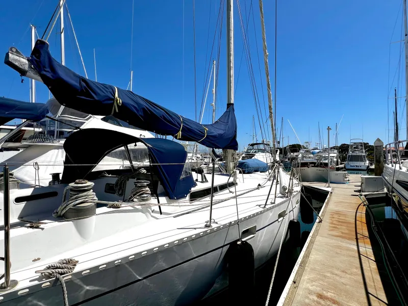 Slide: The Image of 1981 Cheoy Lee Golden Wave sailboat docked at marina under clear blue sky. - 8