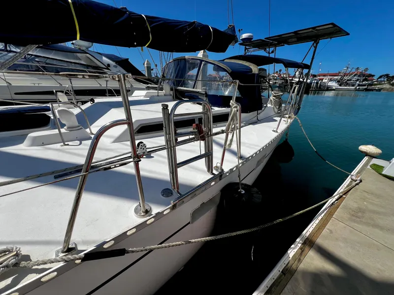Slide: The Image of 1981 Cheoy Lee Golden Wave yacht docked at marina, featuring sleek design and polished railings. - 9