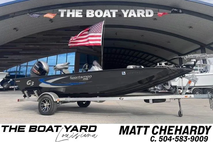 The Image of 2021 G3 Sportsman 1710 boat on trailer at The Boat Yard, Louisiana, with American flag. - 0