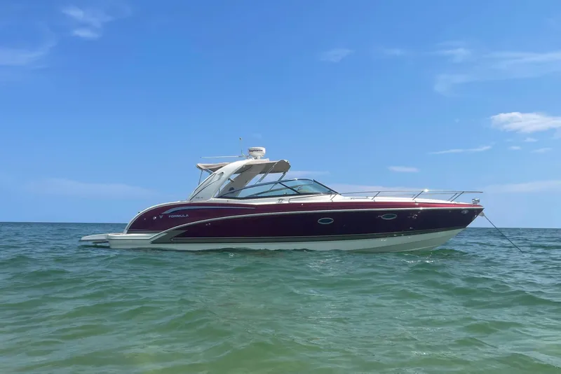 The Image of 2015 Formula 350 Sun Sport boat on calm ocean waters under clear blue sky. - 0