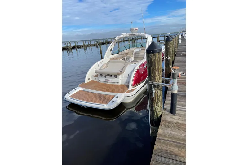 Slide: The Image of 2015 Formula 350 Sun Sport boat docked at a marina under a clear blue sky. - 4