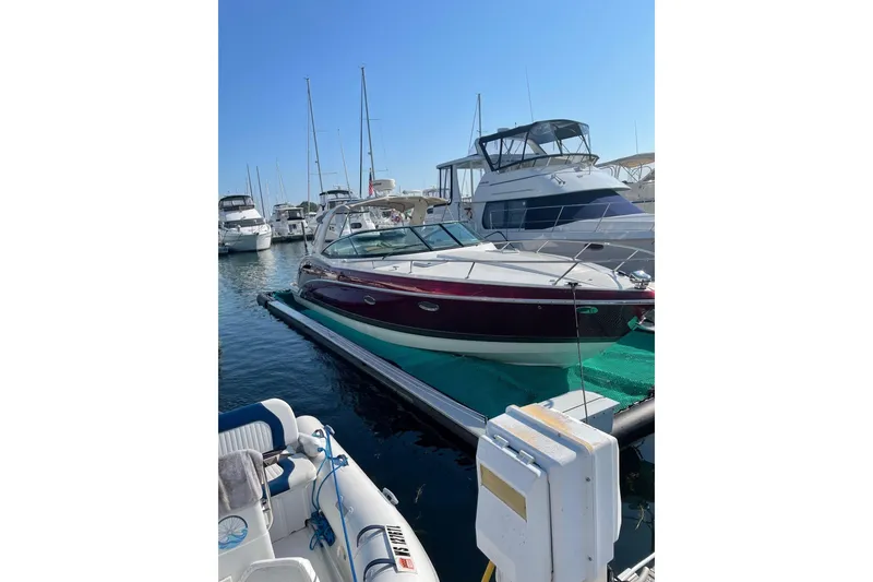 Slide: The Image of 2015 Formula 350 Sun Sport boat docked at marina under clear blue sky. - 6