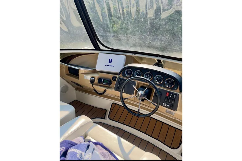 Slide: The Image of Helm of 2001 Carver 396 Aft Cabin Motor Yacht with navigation equipment and steering wheel. - 10