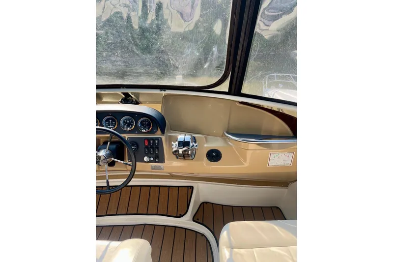 Slide: The Image of 2001 Carver 396 Aft Cabin Motor Yacht helm with steering wheel and control panel. - 12