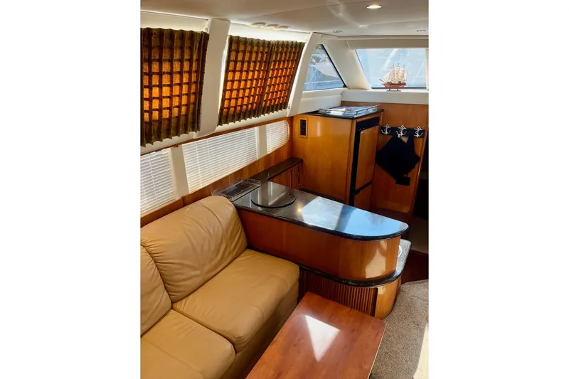 Slide: The Image of Interior of 2001 Carver 396 Aft Cabin Motor Yacht with leather seating and wood accents. - 14