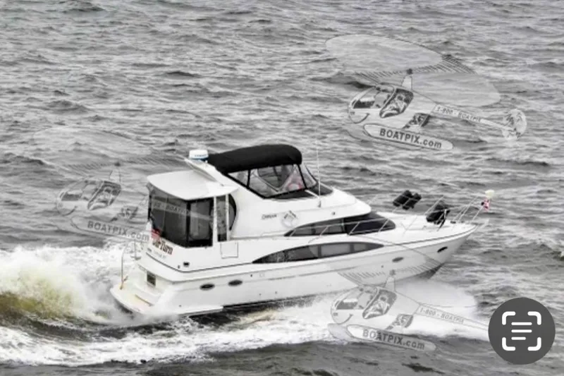 The Image of 2001 Carver 396 Aft Cabin Motor Yacht cruising on open water. - 2