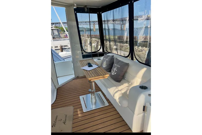 Slide: The Image of 2001 Carver 396 Aft Cabin Motor Yacht interior with seating and table. - 6