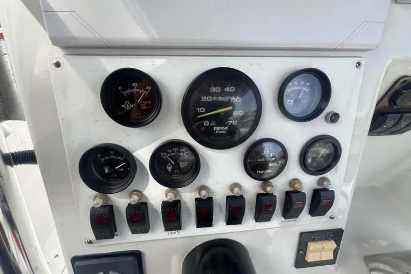 Slide: The Image of Dashboard of a 1997 Stamas 290 Tarpon boat with gauges and switches. - 10