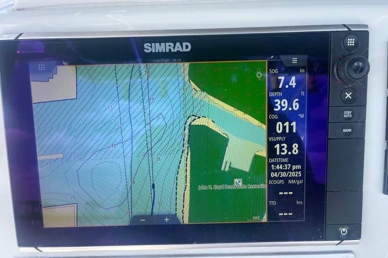 Slide: The Image of Simrad marine GPS display on 1997 Stamas 290 Tarpon, showing navigation data and map. - 11