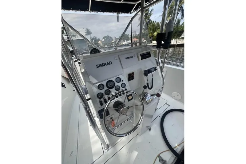 Slide: The Image of 1997 Stamas 290 Tarpon boat helm with Simrad navigation system and steering wheel. - 12