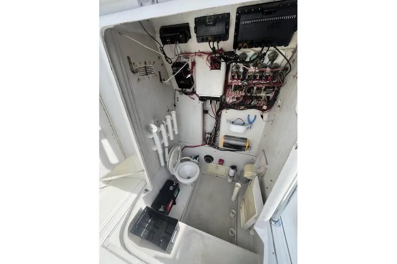 Slide: The Image of 1997 Stamas 290 Tarpon boat interior showing wiring, storage, and equipment setup. - 14