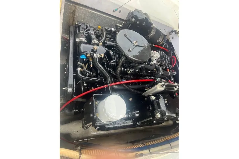 Slide: The Image of Engine of a 1997 Stamas 290 Tarpon boat with visible components and wiring. - 16