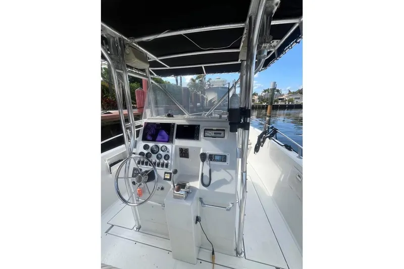 Slide: The Image of 1997 Stamas 290 Tarpon boat cockpit with steering wheel and navigation instruments. - 9