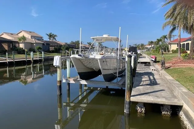 Slide: The Image of 2007 World Cat 250 DC boat docked in a scenic residential canal. - 11