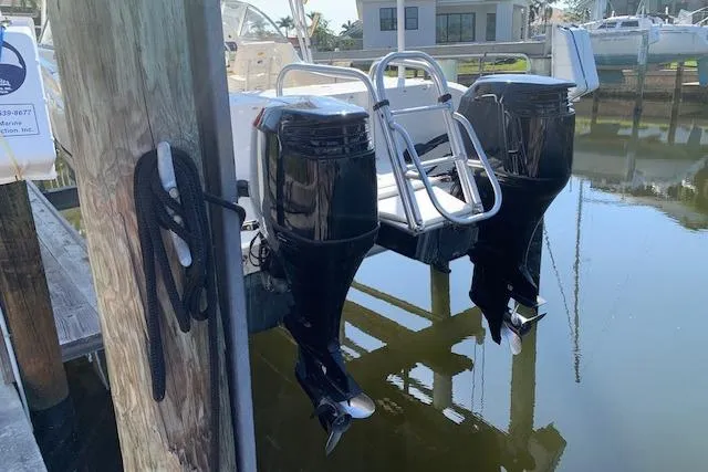 Slide: The Image of 2007 World Cat 250 DC boat with dual outboard motors docked by a pier. - 12