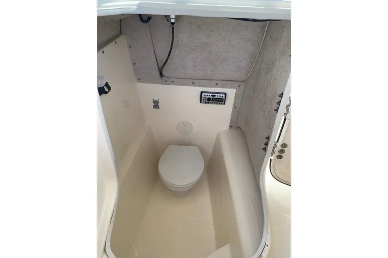 Slide: The Image of 2007 World Cat 250 DC boat interior with compact marine toilet and control panel. - 3