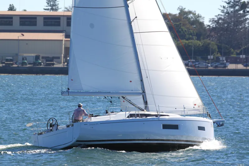 Slide: The Image of 2026 Beneteau Oceanis 37.1 sailing on a sunny day near the shore. - 12