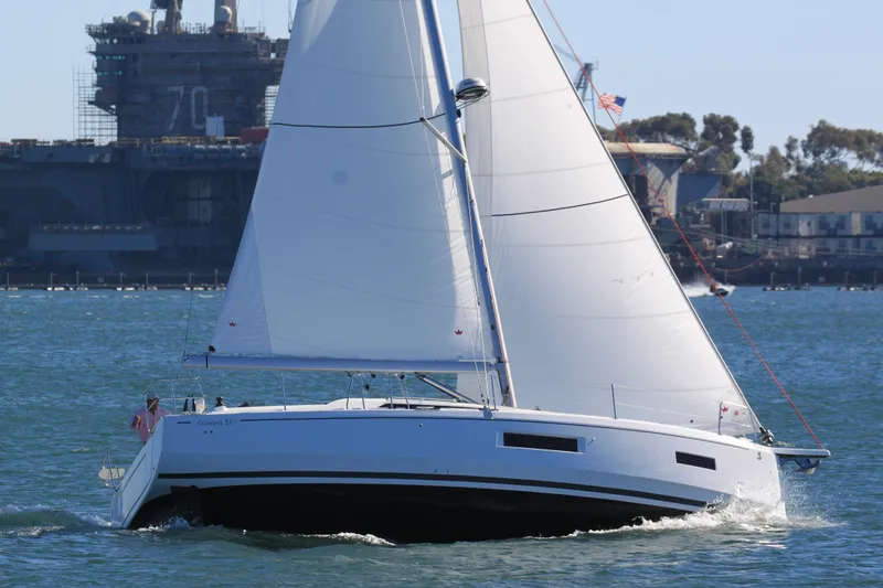 Slide: The Image of 2026 Beneteau Oceanis 37.1 sailboat cruising on open water with sails fully extended. - 18
