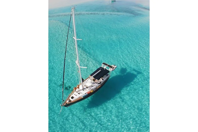 Slide: The Image of Aerial view of 2004 Beneteau 50 sailboat on clear turquoise water. - 1