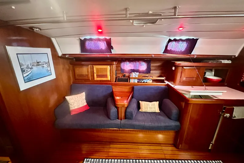 Slide: The Image of Cozy interior of 2004 Beneteau 50 yacht with blue seating and nautical decor. - 12