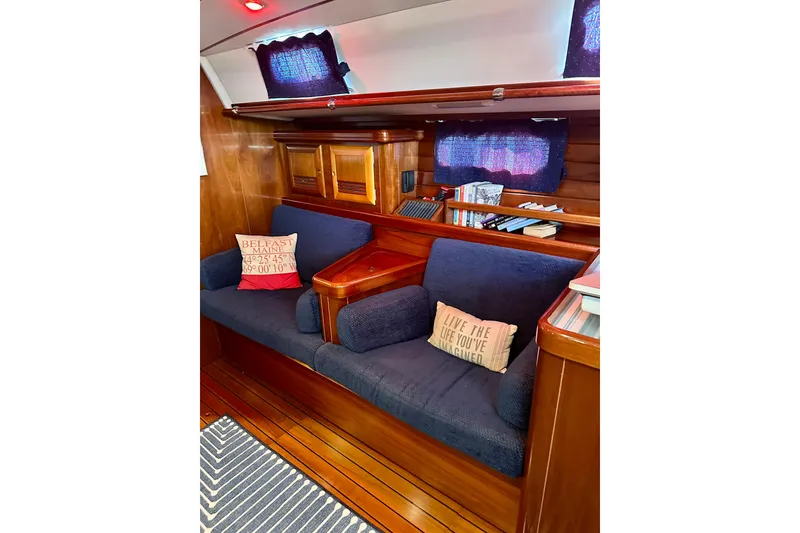 Slide: The Image of Interior of 2004 Beneteau 50 yacht with cozy seating and nautical decor. - 13
