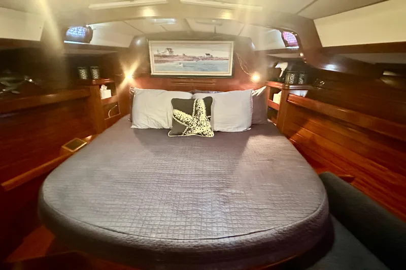 Slide: The Image of Cozy cabin interior of a 2004 Beneteau 50 yacht with a comfortable bed and nautical decor. - 15