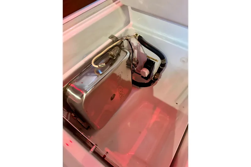 Slide: The Image of Engine compartment of a 2004 Beneteau 50 yacht, showcasing mechanical components. - 28