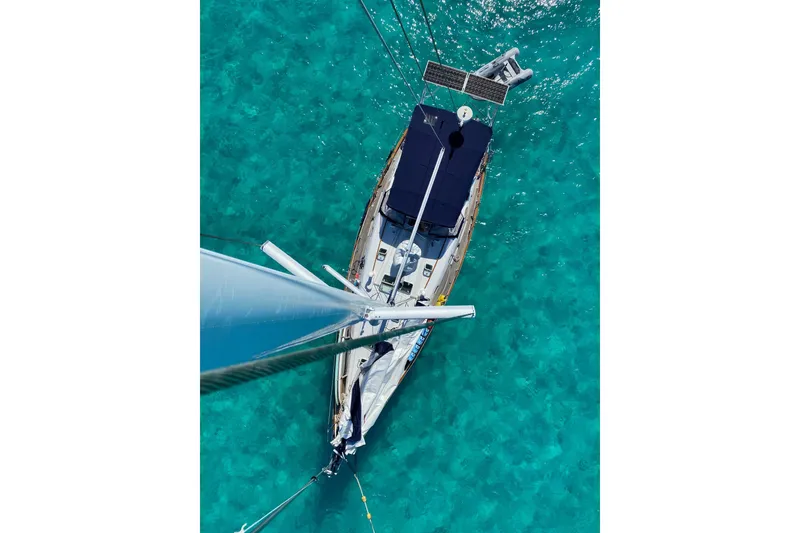 Slide: The Image of Aerial view of 2004 Beneteau 50 sailboat on clear turquoise water. - 3