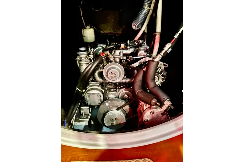 Slide: The Image of Engine of a 2004 Beneteau 50 sailboat, showcasing mechanical components and hoses. - 30