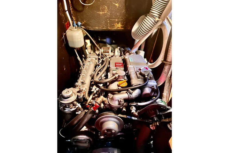 Slide: The Image of Engine compartment of a 2004 Beneteau 50 sailboat, showcasing mechanical components. - 31