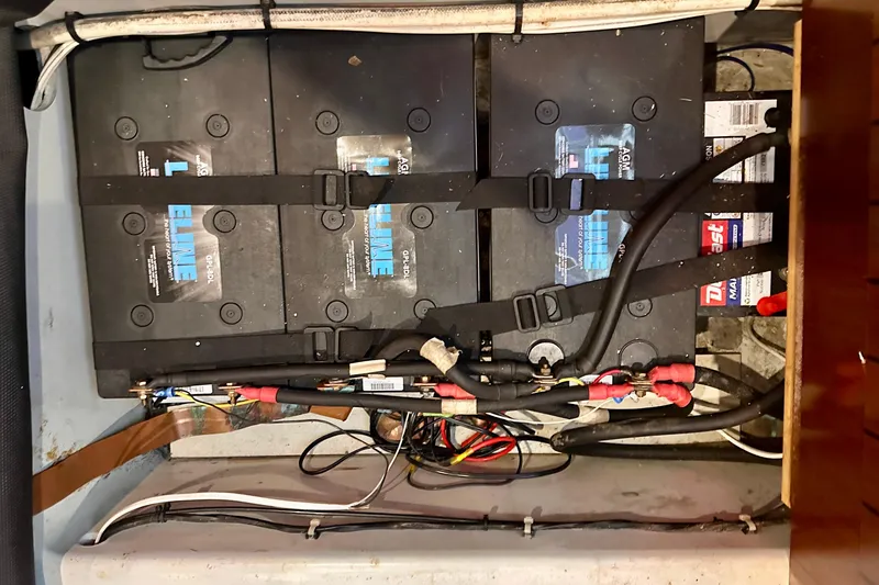 Slide: The Image of Battery compartment of a 2004 Beneteau 50 sailboat with secured wiring. - 33