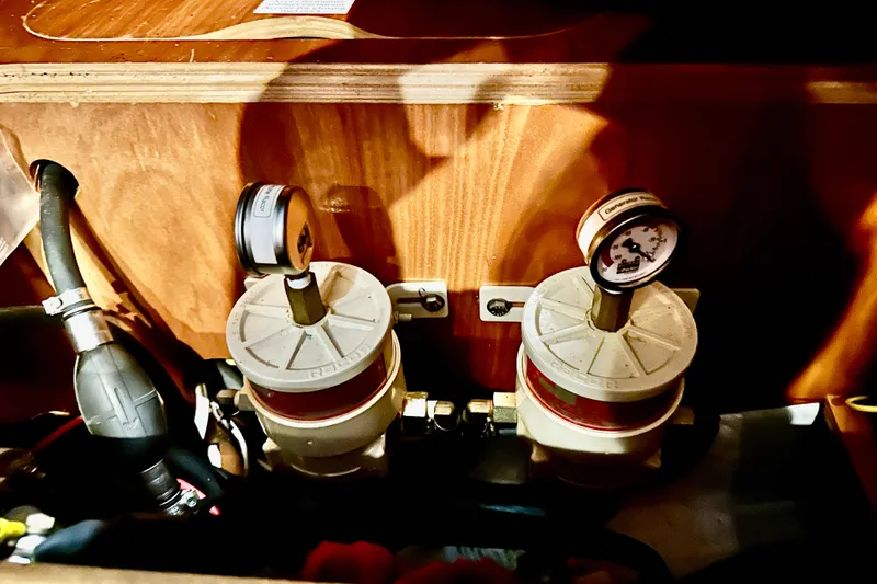 Slide: The Image of Fuel filters and gauges inside a 2004 Beneteau 50 yacht engine compartment. - 34