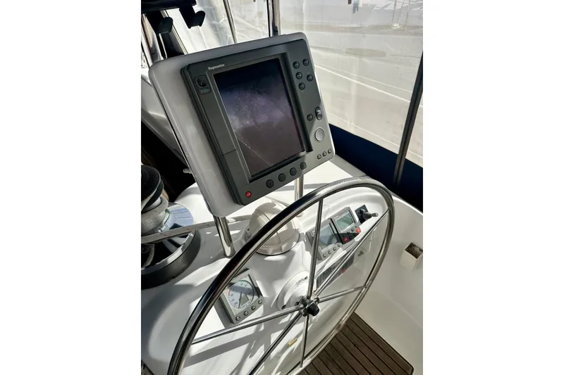 Slide: The Image of Steering wheel and navigation system on a 2004 Beneteau 50 yacht. - 43