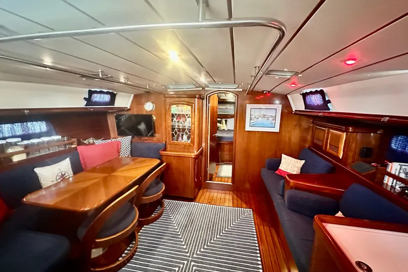 Slide: The Image of Luxurious interior of a 2004 Beneteau 50 yacht with elegant wood finish and cozy seating. - 6