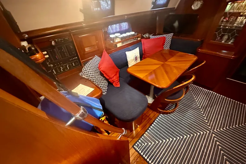 Slide: The Image of Luxurious interior of a 2004 Beneteau 50 yacht with cozy seating and elegant wood finishes. - 7