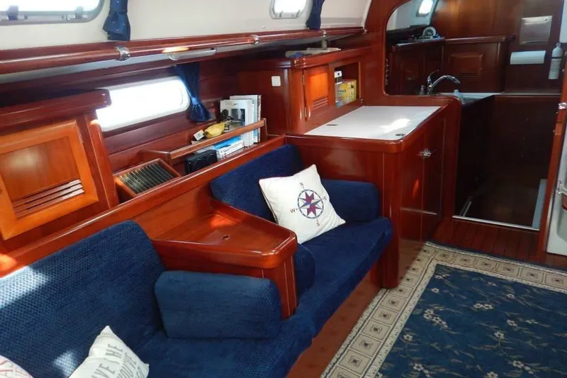 Slide: The Image of Interior of 2004 Beneteau 50 yacht with cozy seating and wooden cabinetry. - 8