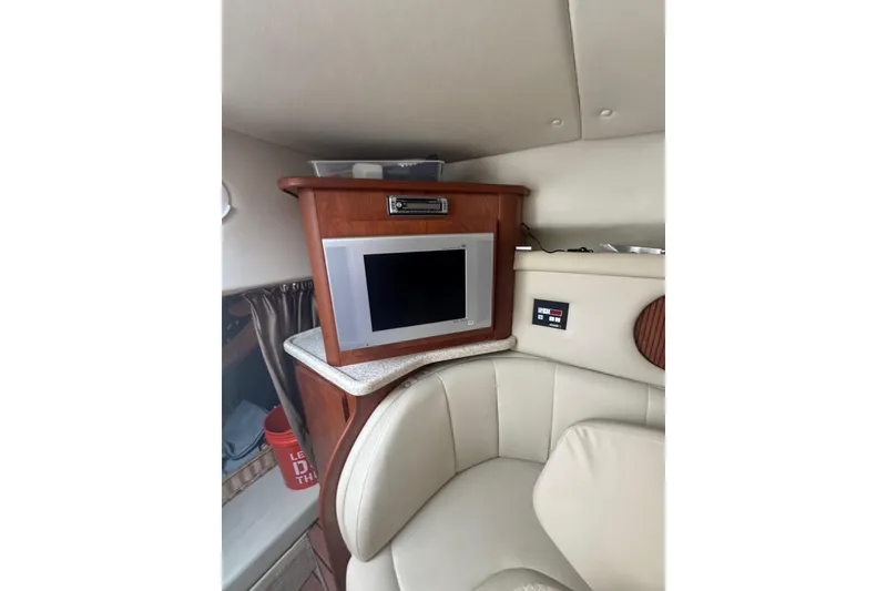 Slide: The Image of 2007 Rinker 320 Express Cruiser interior with TV and seating area. - 13