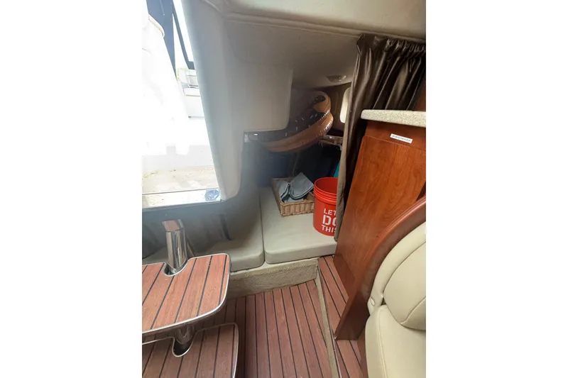 Slide: The Image of Interior of 2007 Rinker 320 Express Cruiser with wood flooring and seating area. - 14