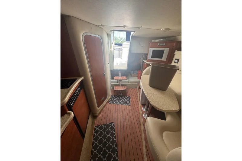Slide: The Image of Interior of 2007 Rinker 320 Express Cruiser with wood flooring and modern amenities. - 16