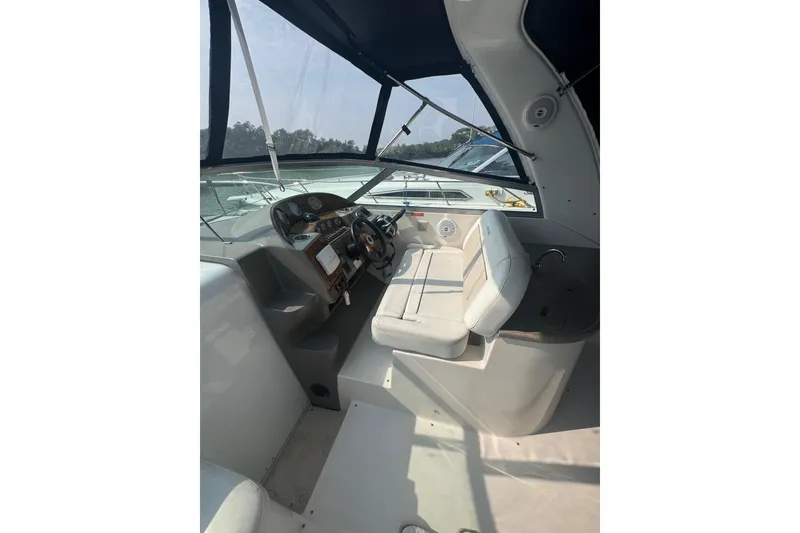 Slide: The Image of 2007 Rinker 320 Express Cruiser cockpit with steering wheel and seating. - 19