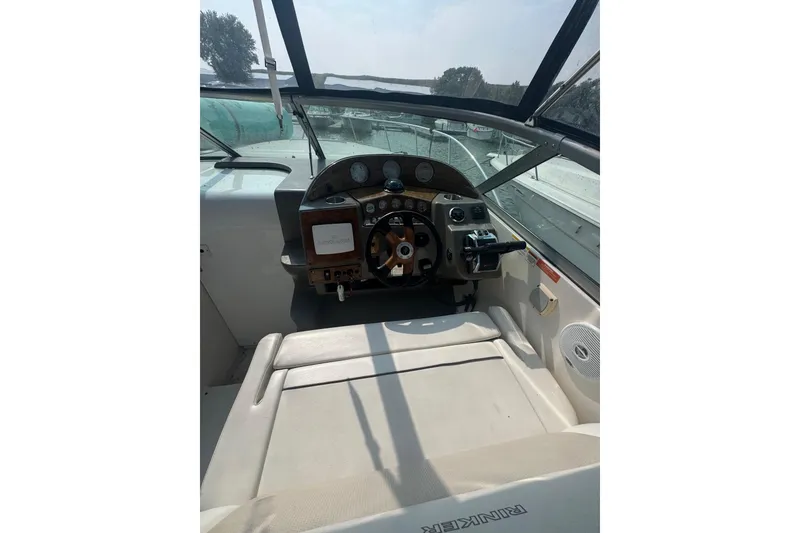 Slide: The Image of 2007 Rinker 320 Express Cruiser cockpit with steering wheel and control panel. - 20