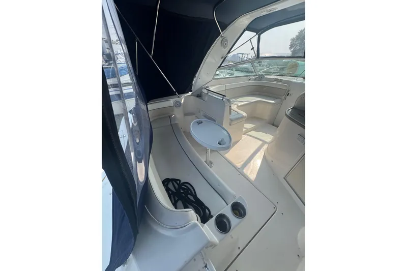 Slide: The Image of 2007 Rinker 320 Express Cruiser interior with seating and table, showcasing spacious design. - 21