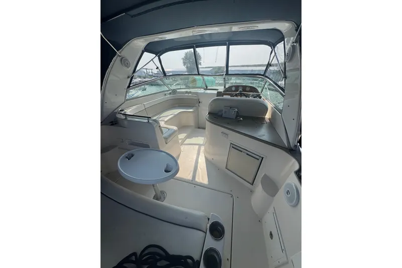 Slide: The Image of 2007 Rinker 320 Express Cruiser interior with seating, table, and helm view. - 22