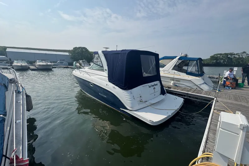 Slide: The Image of 2007 Rinker 320 Express Cruiser docked at a marina, surrounded by other boats. - 3