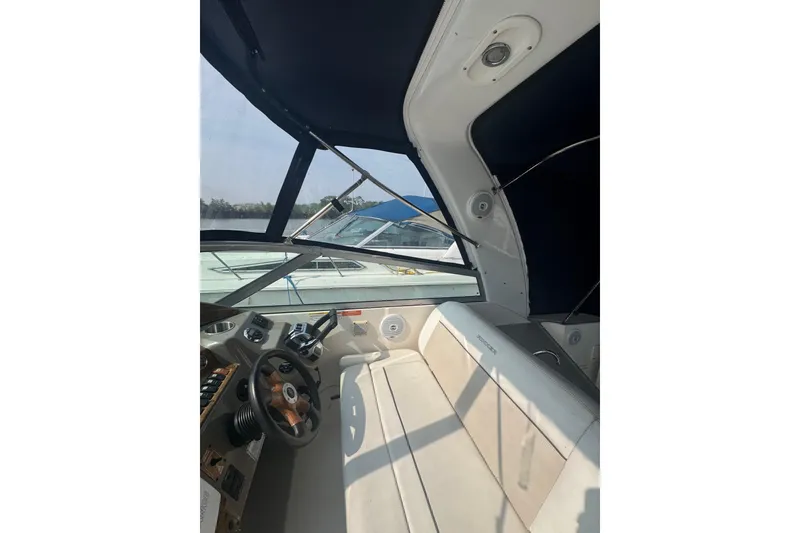 Slide: The Image of 2007 Rinker 320 Express Cruiser interior with steering wheel and seating area. - 8