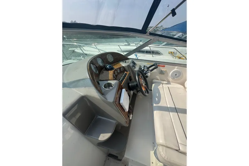 Slide: The Image of 2007 Rinker 320 Express Cruiser helm with steering wheel and instrument panel. - 9
