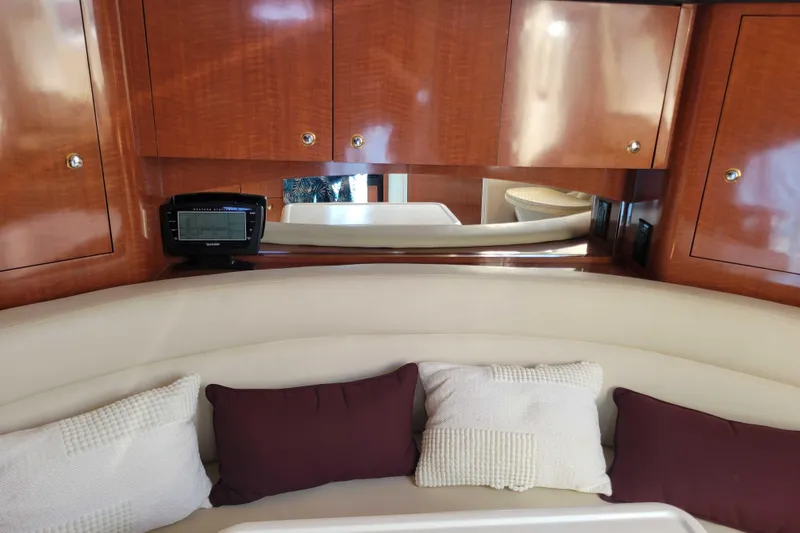 Slide: The Image of Interior of 2003 Sea Ray 320 Sundancer with wood cabinets and cushioned seating. - 19