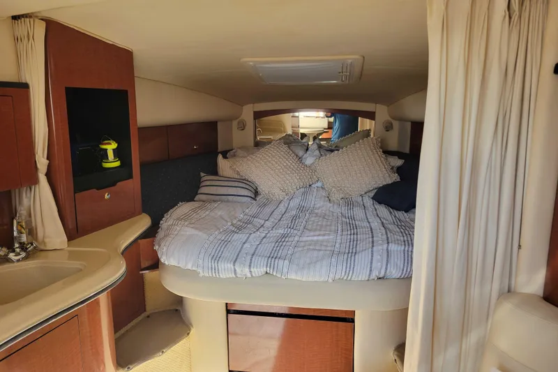 Slide: The Image of Interior cabin of 2003 Sea Ray 320 Sundancer with cozy bed and elegant wood finish. - 20