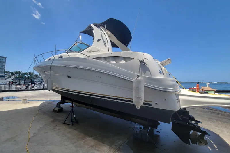 Slide: The Image of 2003 Sea Ray 320 Sundancer yacht on dry dock under clear blue sky. - 3