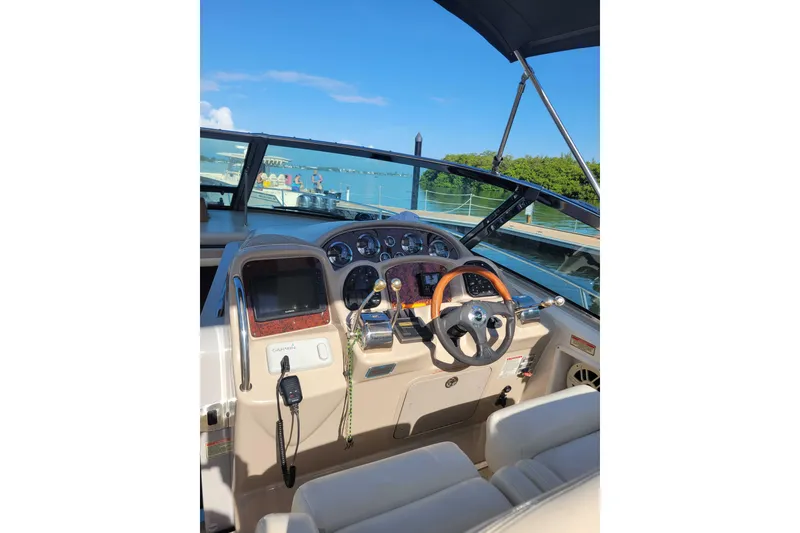 Slide: The Image of Cockpit of 2003 Sea Ray 320 Sundancer with steering wheel and navigation equipment. - 5